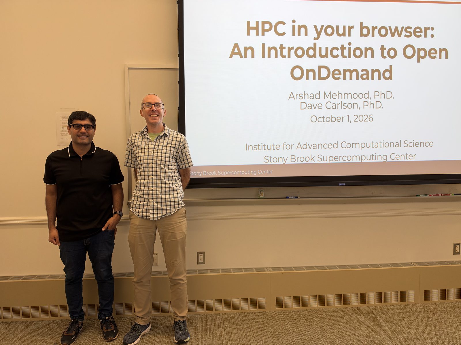 Arshad Mehmood and David Carlson standing beside the opening slide, HPC in your browser: An Introduction to Open OnDemand, October 1, 2026